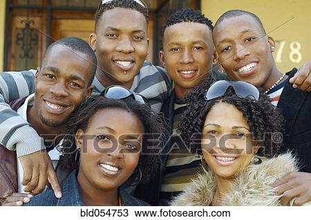 Stock Image - African friends hugging. Fotosearch