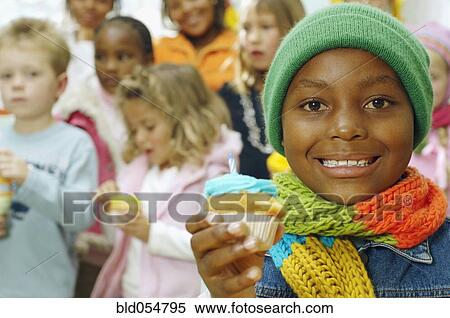 African girl holding cupcake View Large Photo Image Stock Photography - African girl holding cupcake. Fotosearch