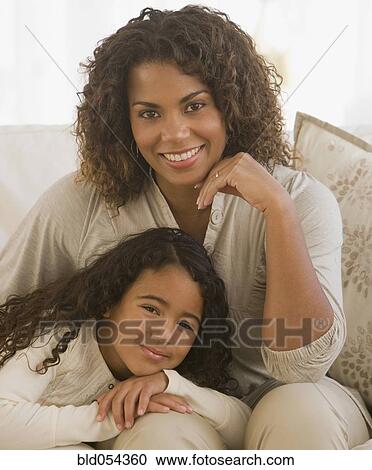 African girl leaning on mother’s lap View Large Photo Image Stock Image - African girl leaning on mother’s lap. Fotosearch