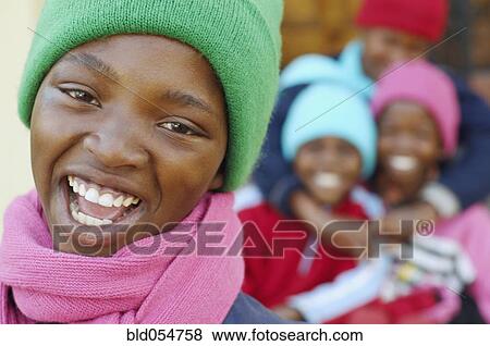 African girl with friends in background View Large Photo Image Stock Photo - African girl with friends in background. Fotosearch