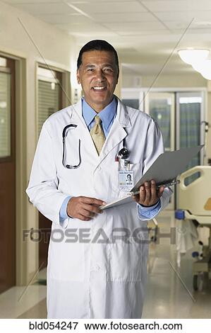 African male doctor holding chart View Large Photo Image Stock Photo - African male doctor holding chart. Fotosearch