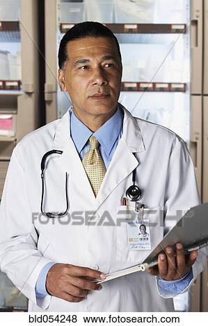 African male doctor holding chart View Large Photo Image Stock Photo - African male doctor holding chart. Fotosearch
