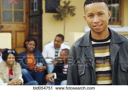 African man with friends in background View Large Photo Image Stock Image - African man with friends in background. Fotosearch