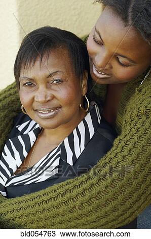 African mother and adult daughter hugging View Large Photo Image Stock Image - African mother and adult daughter hugging. Fotosearch