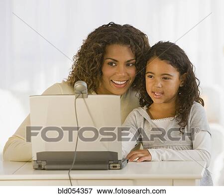 African mother and daughter looking at web cam View Large Photo Image Stock Photo - African mother and daughter looking at web cam. Fotosearch