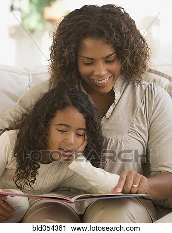 Stock Image - African mother and daughter reading. Fotosearch
