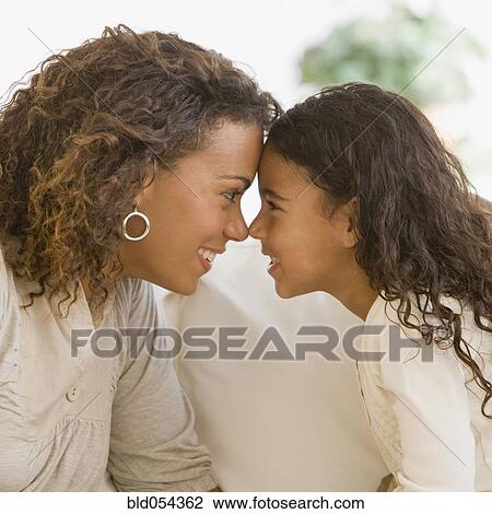 Stock Image - African mother and daughter touching noses. Fotosearch