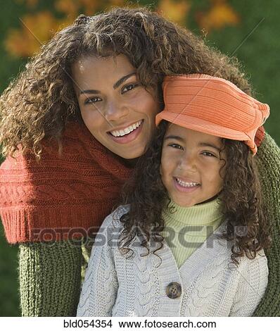 Picture - African mother hugging daughter. Fotosearch