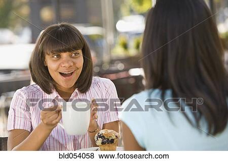 Stock Photo - African teenaged girl talking to friend. Fotosearch