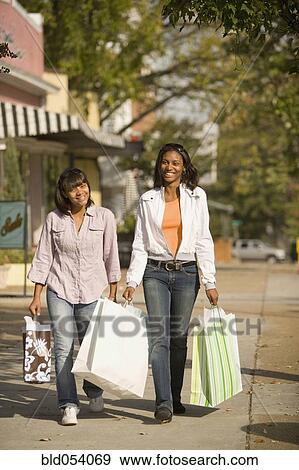 African teenaged girls carrying shopping bags View Large Photo Image Stock Photo - African teenaged girls carrying shopping bags. Fotosearch