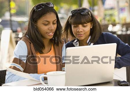 African teenaged girls looking at laptop View Large Photo Image Stock Photograph - African teenaged girls looking at laptop. Fotosearch