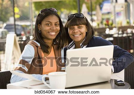 African teenaged girls next to laptop View Large Photo Image Stock Photo - African teenaged girls next to laptop. Fotosearch