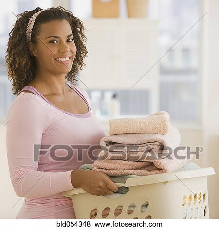 African woman carrying laundry basket View Large Photo Image Stock Photo - African woman carrying laundry basket. Fotosearch