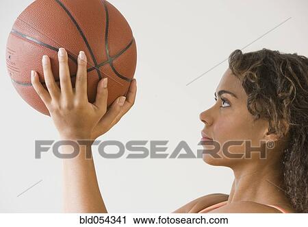 African woman holding basketball View Large Photo Image Stock Image - African woman holding basketball. Fotosearch