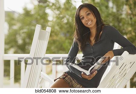 Stock Photo - African woman holding book. Fotosearch