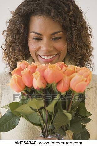 African woman holding bouquet of flowers View Large Photo Image Stock Image - African woman holding bouquet of flowers. Fotosearch