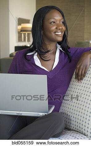 African woman holding laptop View Large Photo Image Stock Photo - African woman holding laptop. Fotosearch