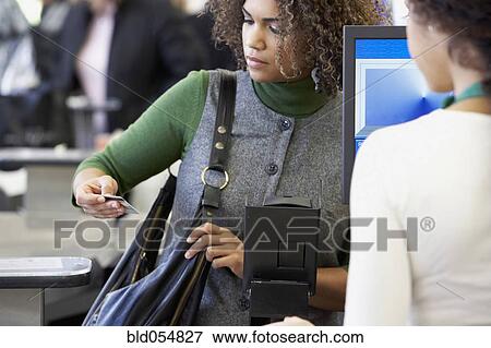African woman looking at credit card View Large Photo Image Stock Photo - African woman looking at credit card. Fotosearch