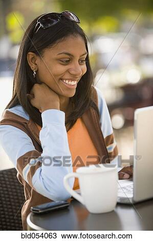 African woman looking at laptop View Large Photo Image Stock Image - African woman looking at laptop. Fotosearch