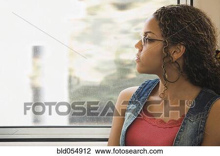 African woman looking out train window View Large Photo Image Stock Image - African woman looking out train window. Fotosearch