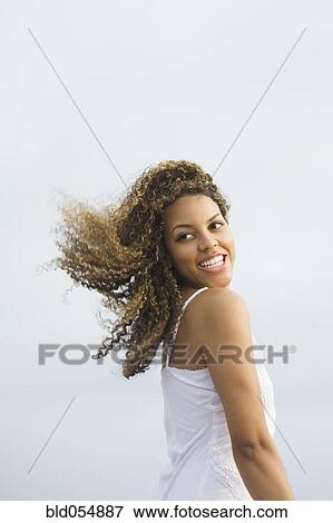 Stock Photo - African woman looking over shoulder. Fotosearch