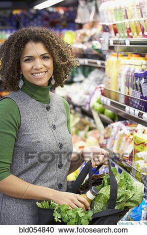 African woman shopping at grocery store View Large Photo Image Stock Image - African woman shopping at grocery store. Fotosearch
