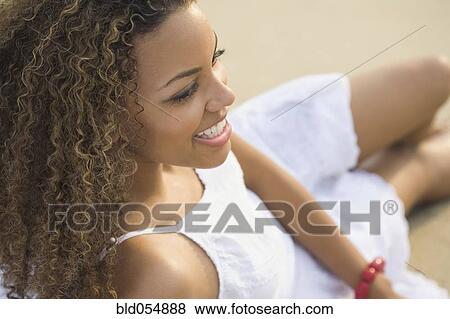 African woman sitting on beach View Large Photo Image Stock Photo - African woman sitting on beach. Fotosearch