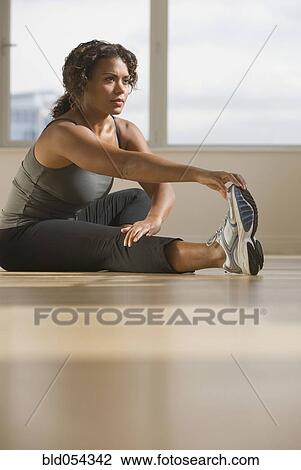 Stock Image - African woman stretching. Fotosearch