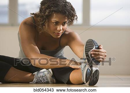 Stock Image - African woman stretching. Fotosearch