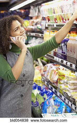 African woman talking on cell phone View Large Photo Image Stock Photo - African woman talking on cell phone. Fotosearch