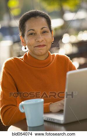 African woman typing on laptop View Large Photo Image Picture - African woman typing on laptop. Fotosearch