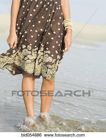 African woman wading in ocean surf View Large Photo Image Stock Photograph - African woman wading in ocean surf. Fotosearch
