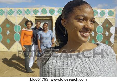 Stock Image - African woman with friends in background. Fotosearch