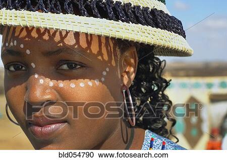 Stock Image - African woman with paint on face. Fotosearch