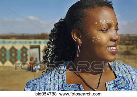 Stock Photo - African woman with paint on face. Fotosearch