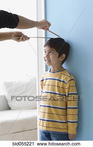 Asian boy having height measured on wall View Large Photo Image Stock Image - Asian boy having height measured on wall. Fotosearch