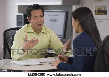 Asian businessman talking to coworker View Large Photo Image Stock Image - Asian businessman talking to coworker. Fotosearch