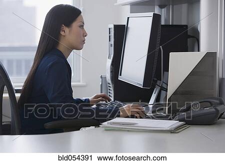 Asian businesswoman looking at computer View Large Photo Image Stock Image - Asian businesswoman looking at computer. Fotosearch