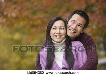 Asian couple hugging View Large Photo Image Stock Image - Asian couple hugging. Fotosearch