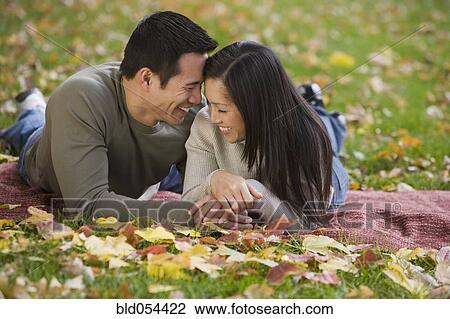 Asian couple laying on blanket View Large Photo Image Stock Image - Asian couple laying on blanket. Fotosearch