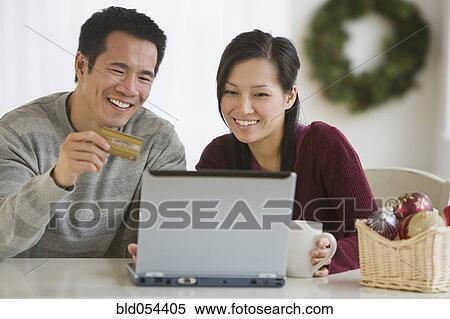 Asian couple shopping online View Large Photo Image Stock Photography - Asian couple shopping online. Fotosearch