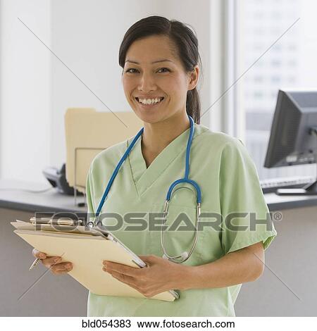 Asian female doctor holding chart View Large Photo Image Stock Image - Asian female doctor holding chart. Fotosearch