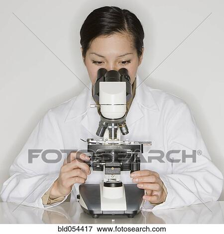 Asian female scientist looking into microscope View Large Photo Image Stock Photo - Asian female scientist looking into microscope. Fotosearch