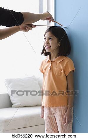 Asian girl having height measured on wall View Large Photo Image Stock Image - Asian girl having height measured on wall. Fotosearch
