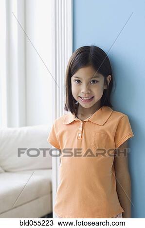 Asian girl leaning on wall View Large Photo Image Stock Image - Asian girl leaning on wall. Fotosearch