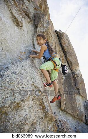 Asian girl rock climbing View Large Photo Image Stock Photo - Asian girl rock climbing. Fotosearch