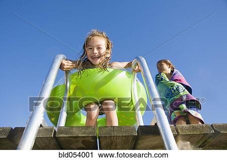 Asian girl with inner tube on dock View Large Photo Image Stock Image - Asian girl with inner tube on dock. Fotosearch
