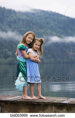 Asian sisters hugging on dock View Large Photo Image Stock Photography - Asian sisters hugging on dock. Fotosearch