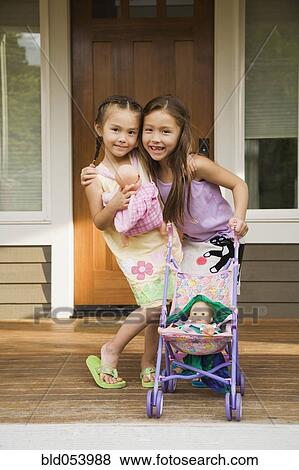 Asian sisters hugging View Large Photo Image Stock Photo - Asian sisters hugging. Fotosearch