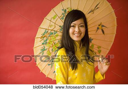 Asian woman holding parasol View Large Photo Image Stock Photo - Asian woman holding parasol. Fotosearch